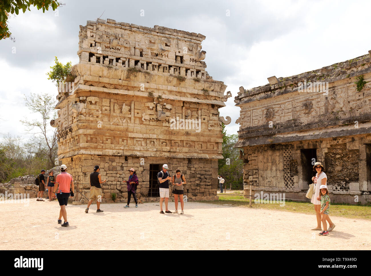 Chichen Itza mayan ruins - Tourists at La Iglesia or The church, a small temple with intricate carvings, Chichen Itza, Yucatan, Mexico Latin America Stock Photo