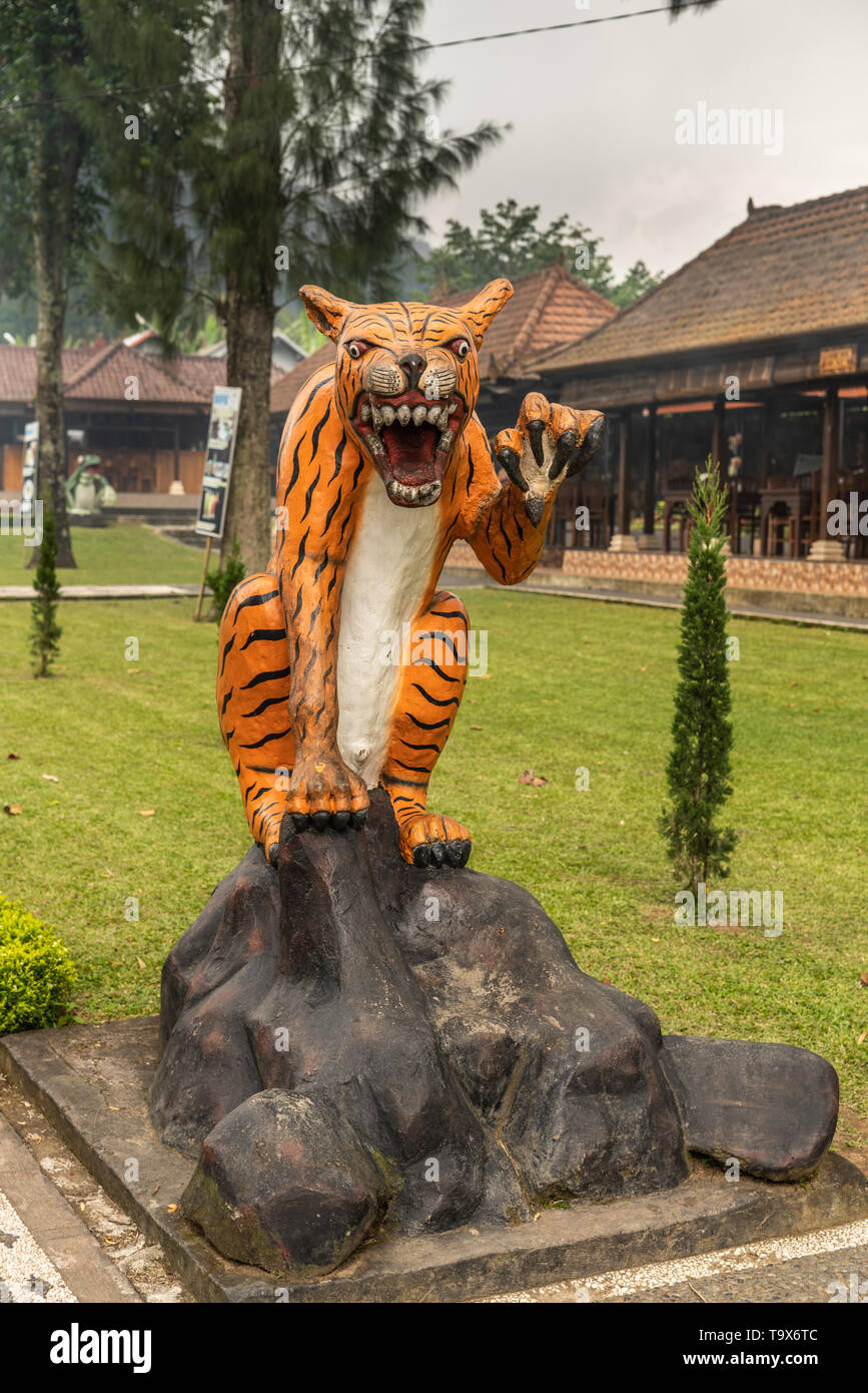 Bali, Indonesia - February 25, 2019: Ulun Danu Beratan Temple complex in Bedoegoel. Effigy of Tiger in park. Stock Photo