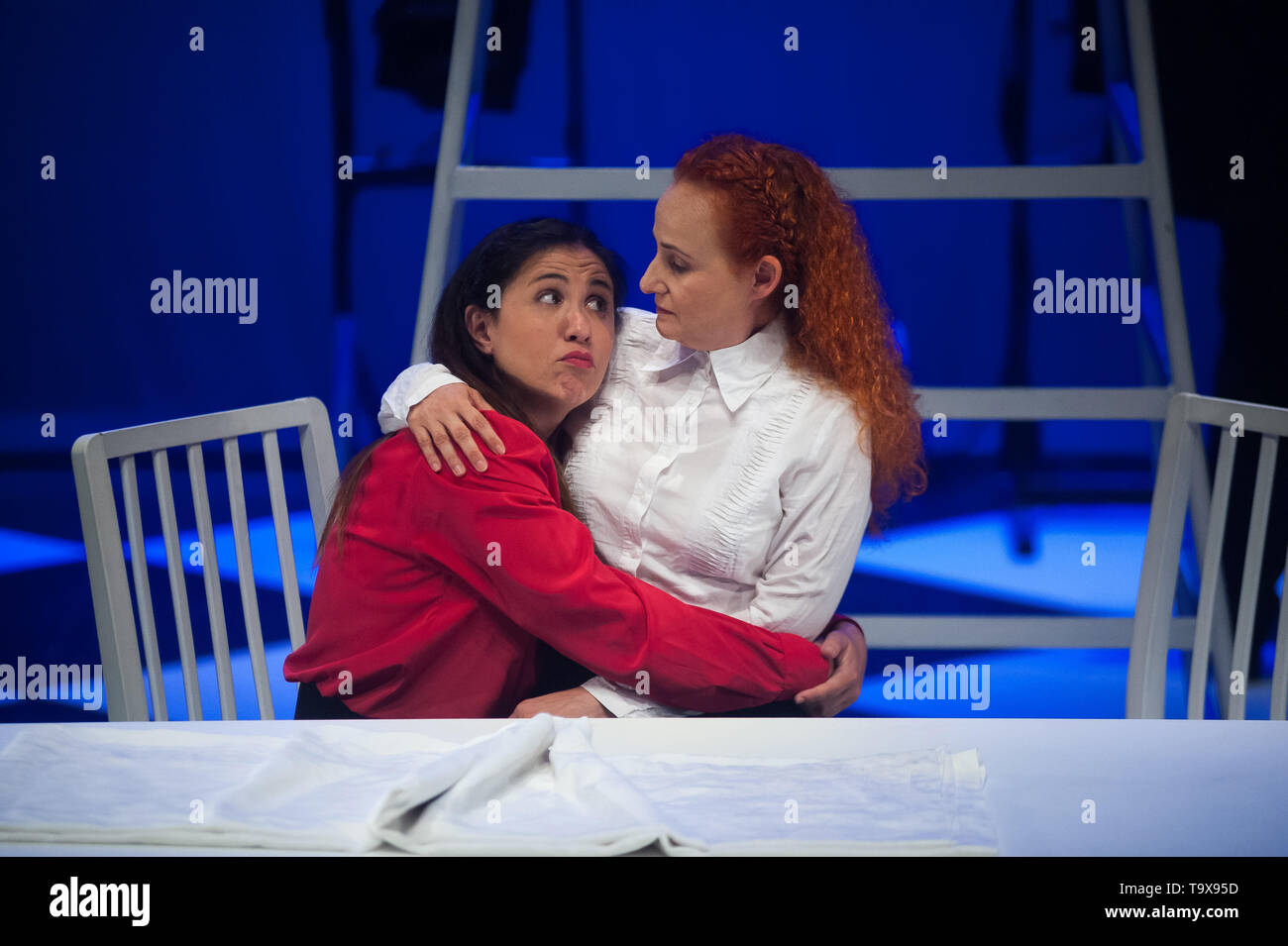 Actors are seen on the stage embraced as they perform during a general rehearsal of the work 'Multiple' inside at theatre Echegaray, directed by Spanish Julio Fraga with text of Spanish journalist Marga Dorao. 'Multiple' is about a love, lack of freedom and fundamentalism story based in poligamous relationships between Alma (a woman that can not have childrens), Bárbara and their husband Jacob. Actors seen on the stage performing during a general rehearsal of 'Multiple' at theatre Echegaray, directed by Julio Fraga with text of Spanish journalist Marga Dorao. 'Multiple' is about a love, lack o Stock Photo