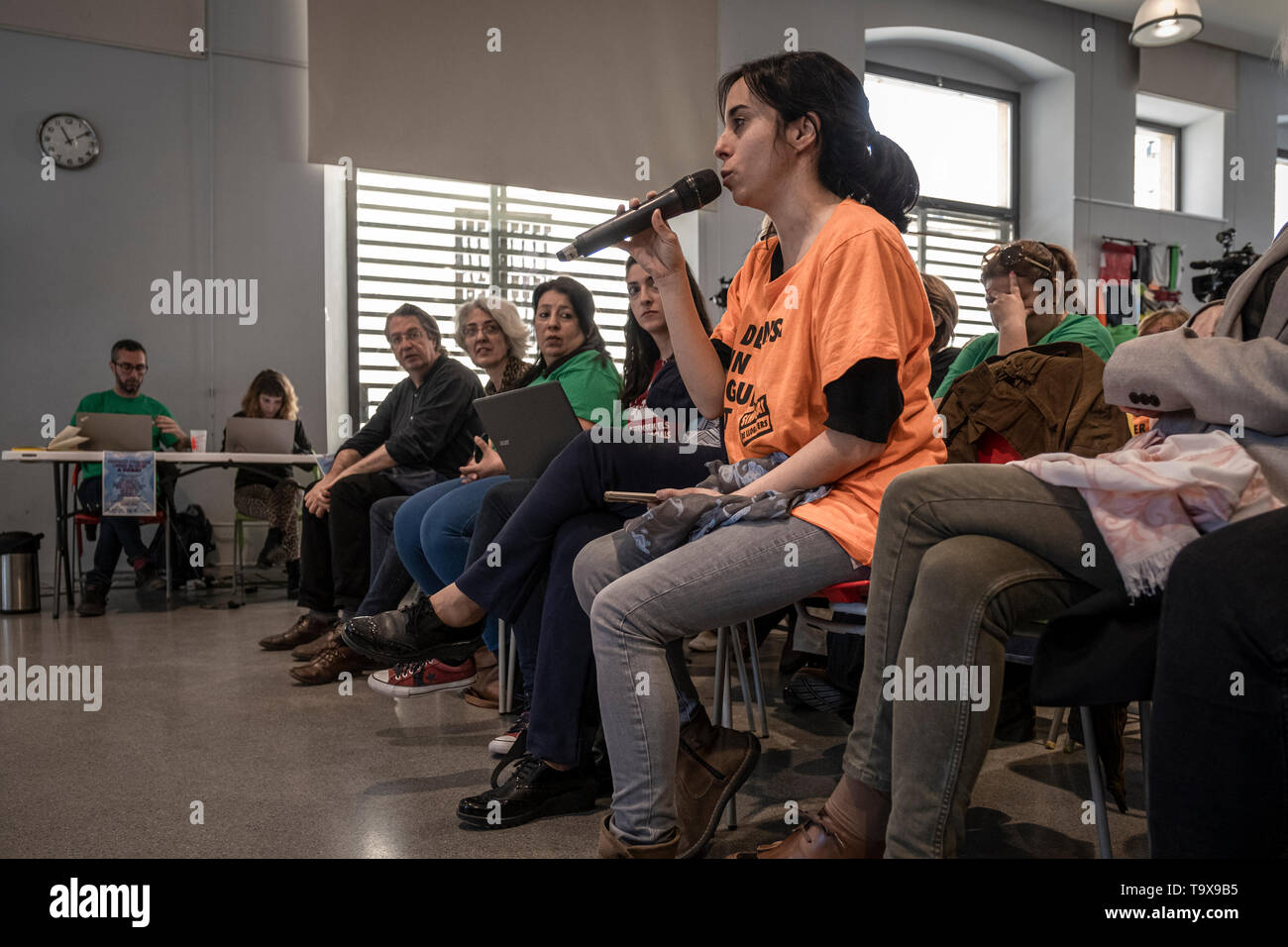 A member of the Tenants' Union, is seen asking a question during the debate. The candidates for Barcelona City Council debated on housing and the model of the city, the debate was organized by various social entities. The candidates answered very specific questions about the right to housing and the city model formulated by members of the main social entities. Stock Photo