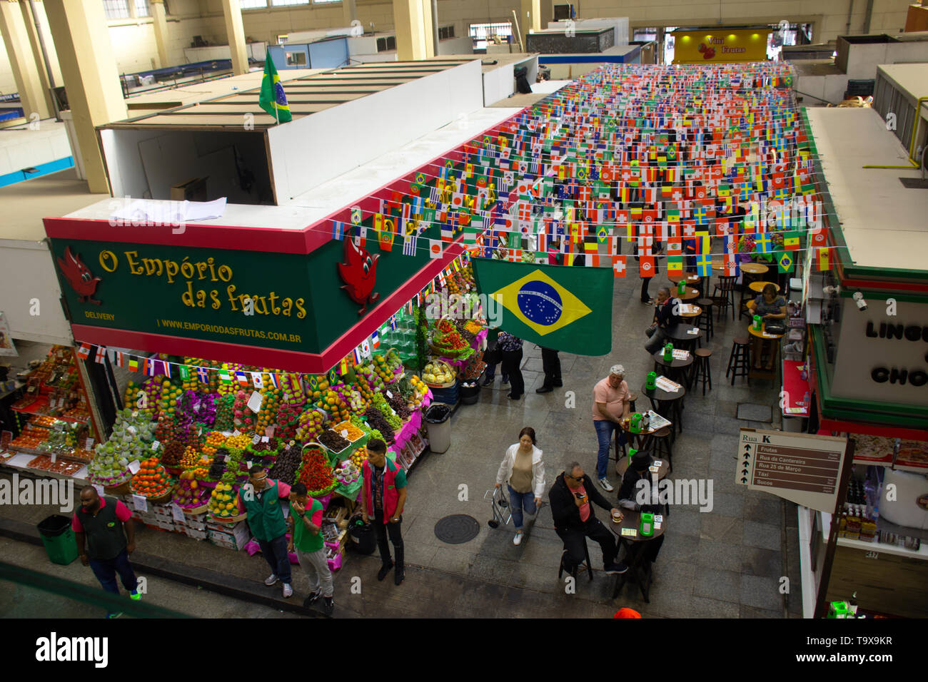 Country flags decorate the row of snack stops at the Municipal Market, Sao Paulo, Brazil Stock Photo