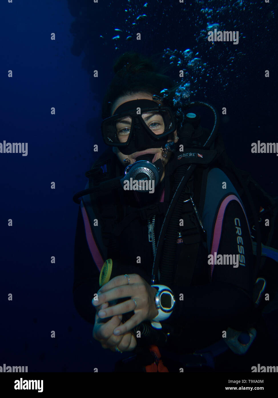 Woman scuba diver (existing model release) underwater enjoying the coral reef of Bunaken National Park, Sulawesi, Indonesia Stock Photo