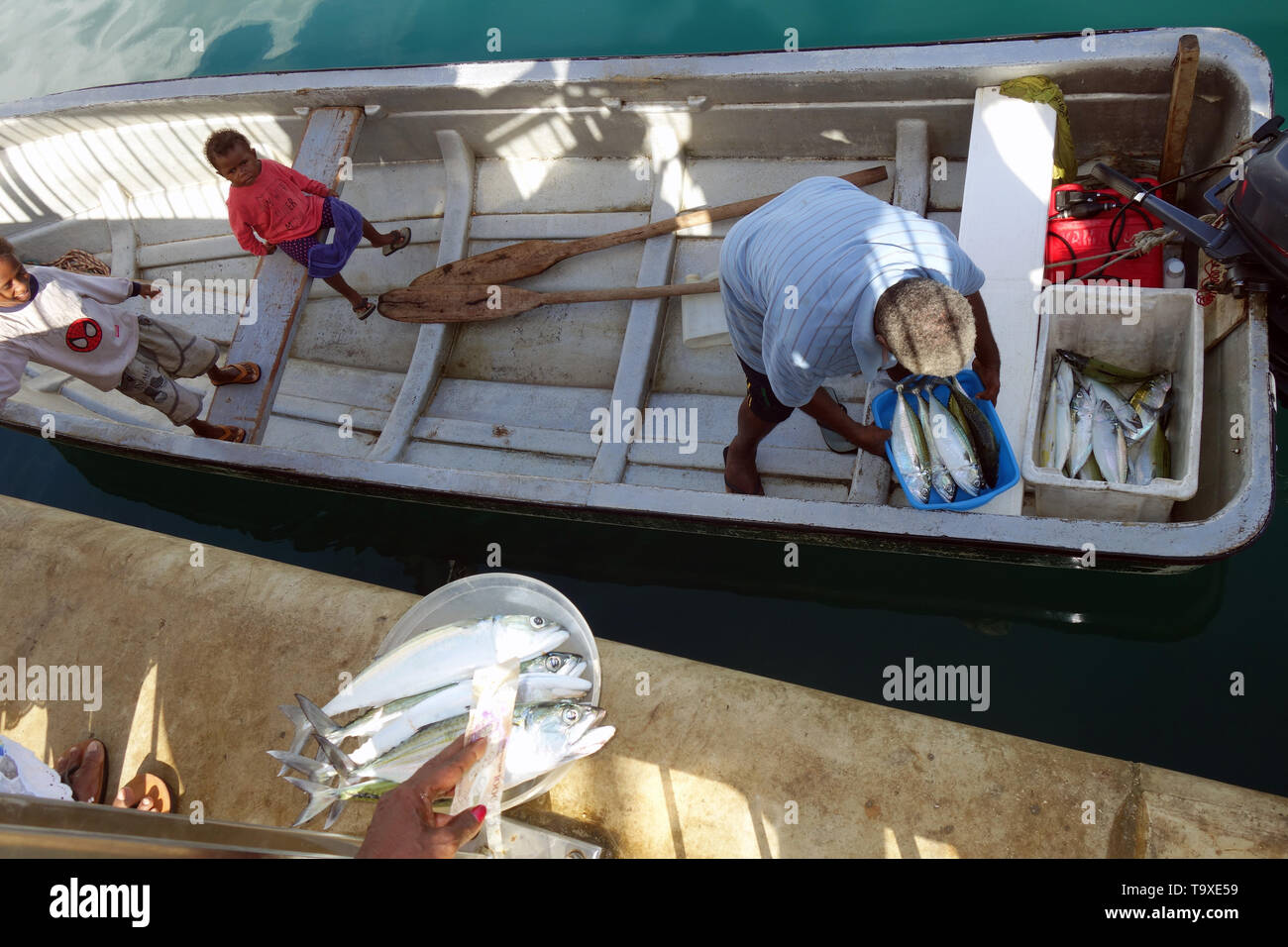 Buying fish from fisherman at dock, Port Vila, Efate, Vanuatu. No MR or PR Stock Photo