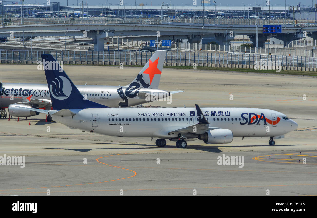 Osaka, Japan - Apr 18, 2019.  B-5453 Shandong Airlines Boeing 737-800 taxiing on runway of Kansai Airport (KIX) in Osaka, Japan. Stock Photo