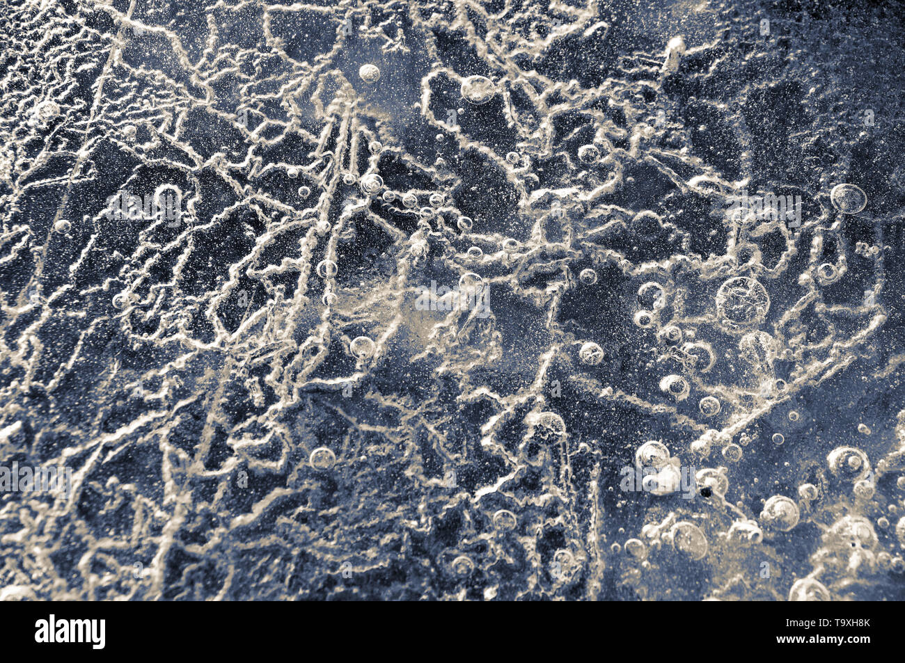 Texture abstract closeup background ice with grooves, furrows, and bubbles of air cought by frost in the mass of wated while freezing Stock Photo