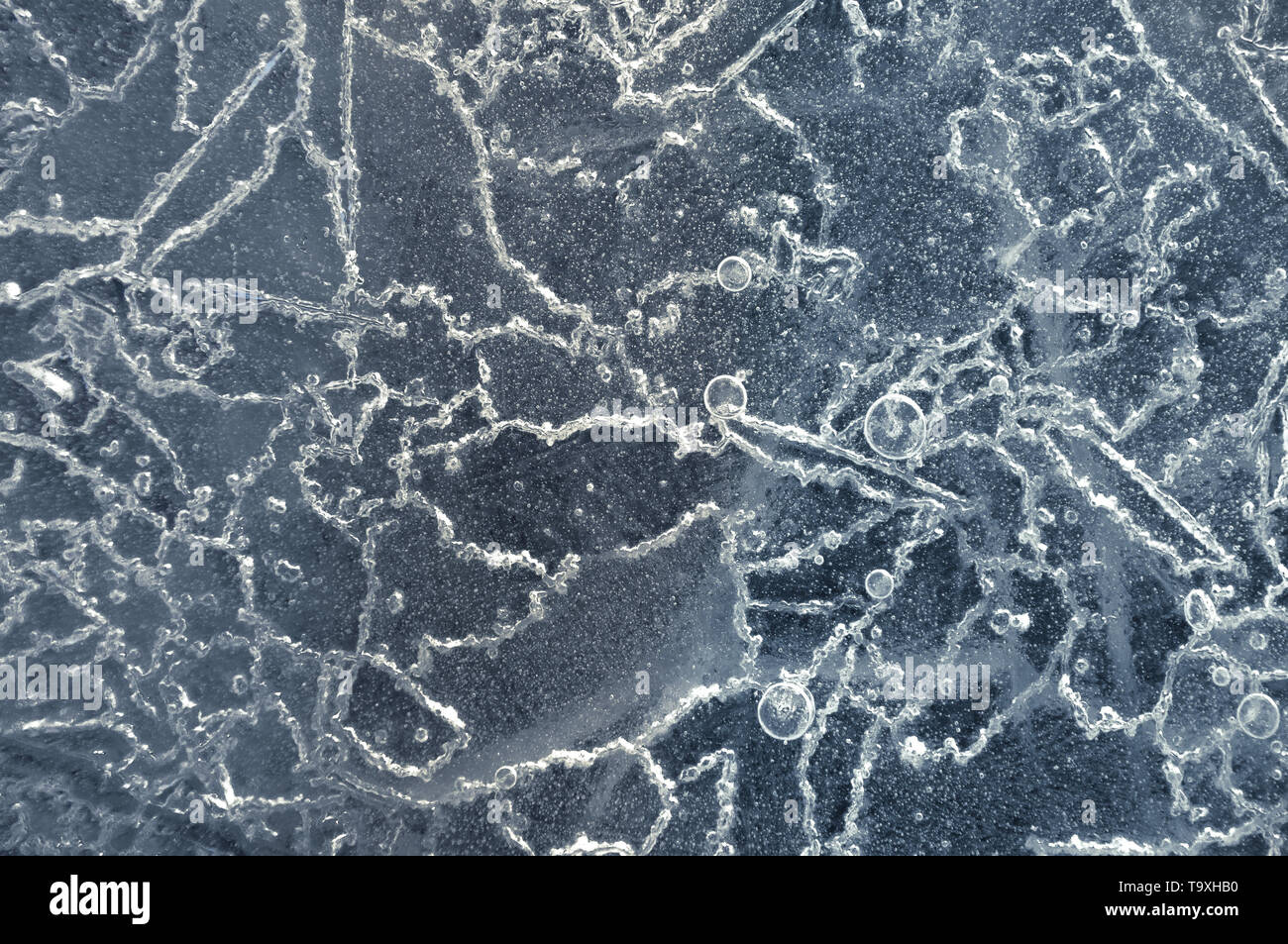 Texture abstract closeup background ice with grooves, furrows, and bubbles of air cought by frost in the mass of wated while freezing Stock Photo