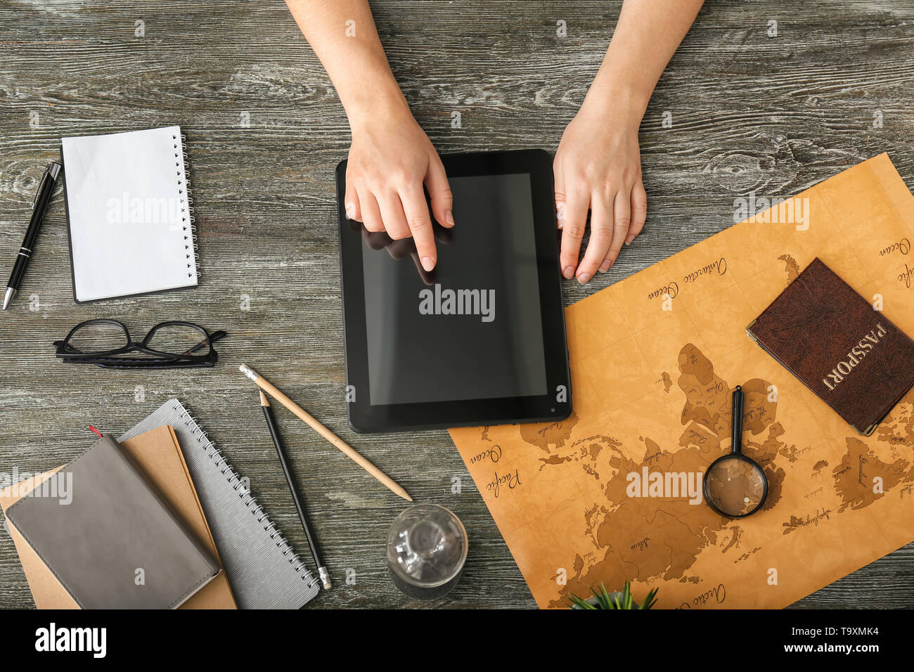 Woman with tablet computer choosing country to spend her vacation Stock ...