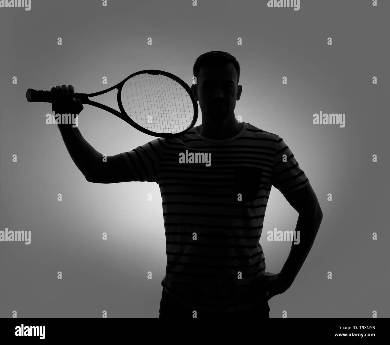 Silhouette of young man with racket on grey background Stock Photo - Alamy