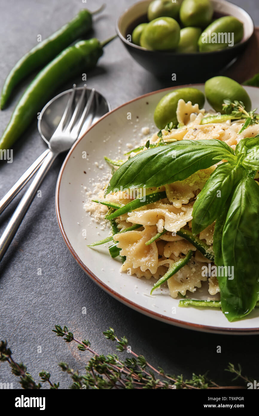 Plate with tasty pasta on grey table Stock Photo