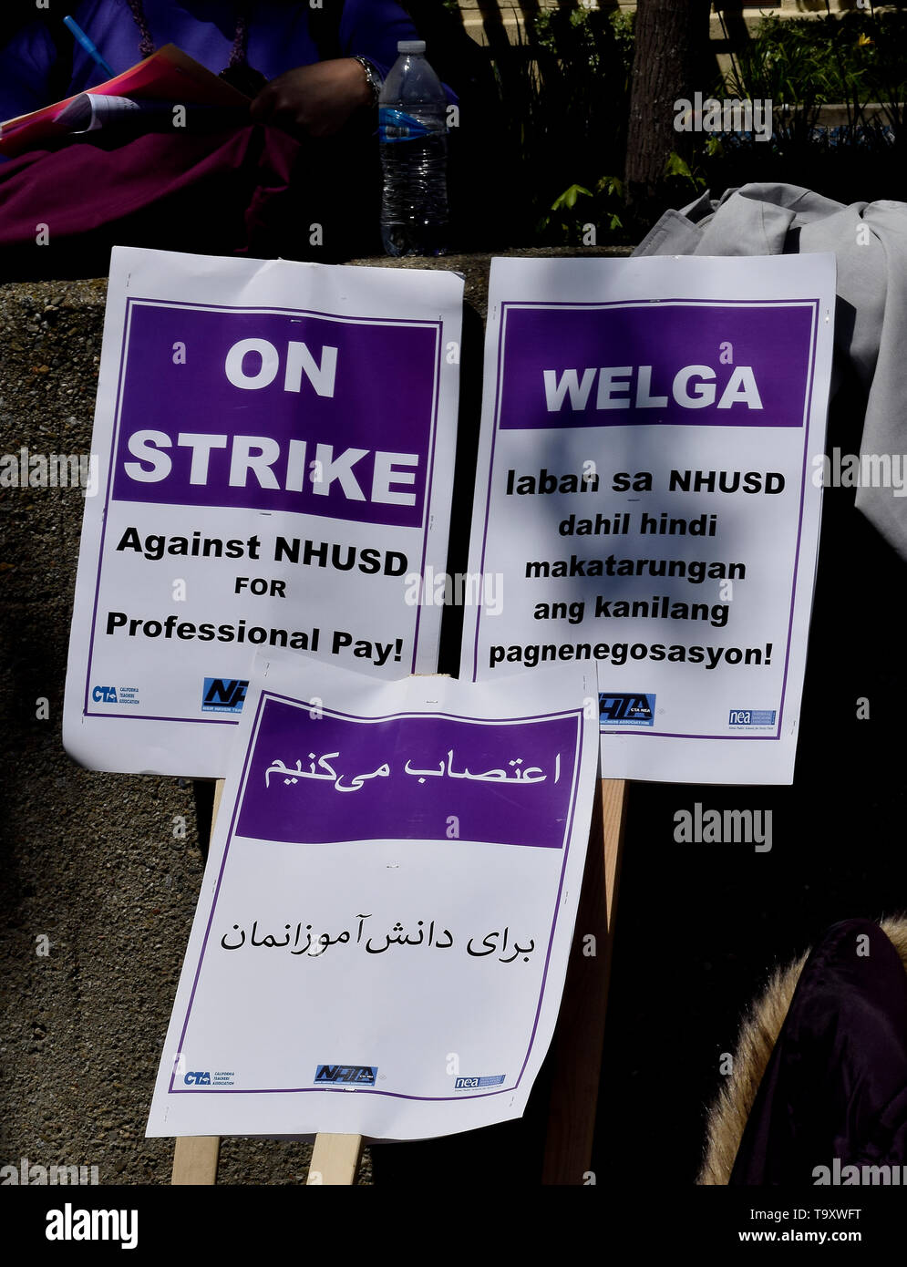 on strike picket signs in multiple languages, for professional pay, by New Haven Teachers Association against the New Haven Unified School District in Union City, California, on May 20, 2019 Stock Photo