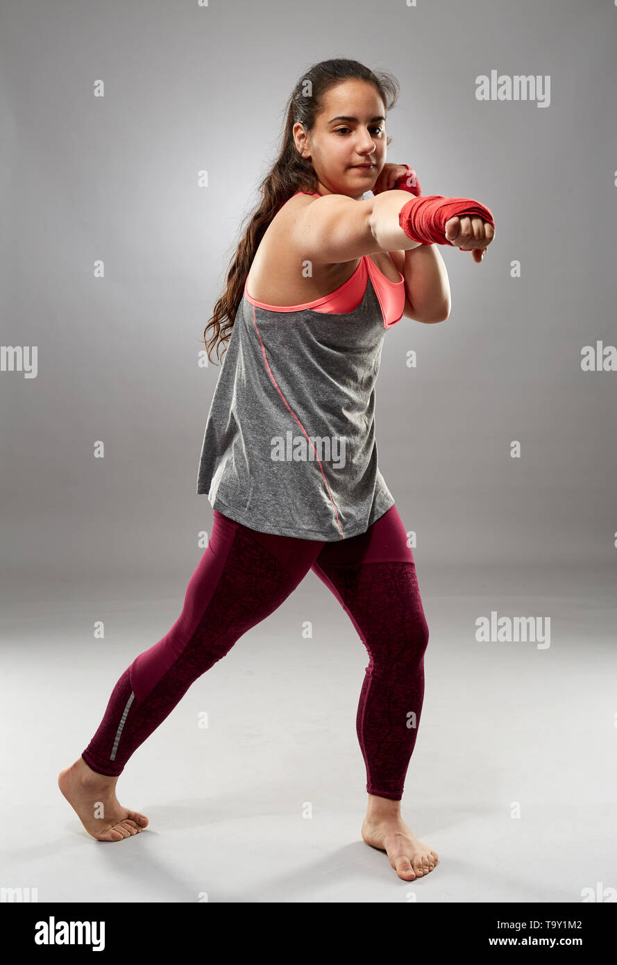 Young kickboxing female fighter in hand wraps, barefoot Stock Photo Alamy