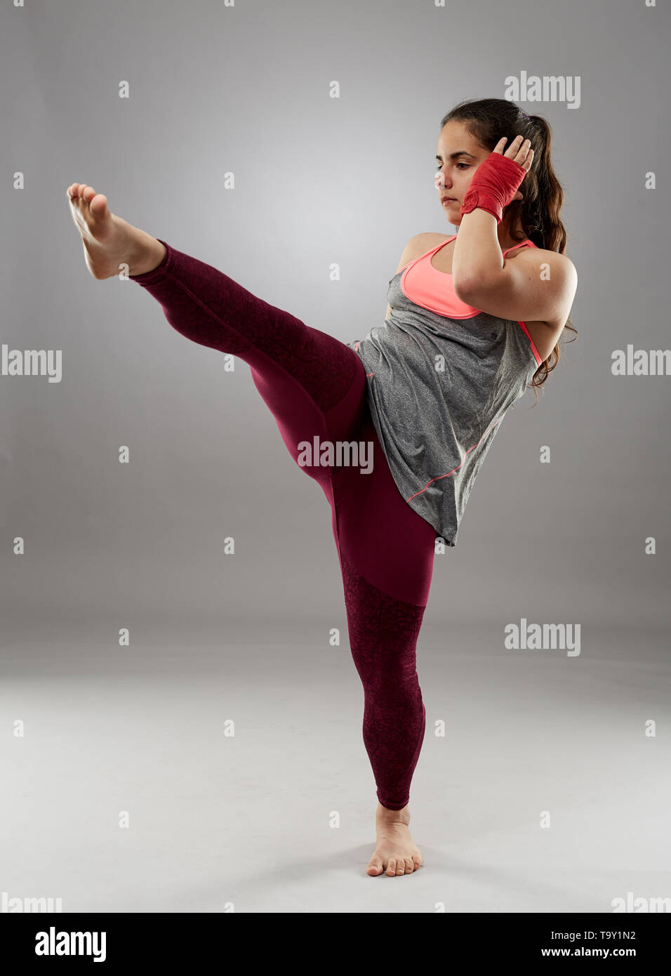 Young kickboxing female fighter in hand wraps, barefoot Stock Photo Alamy