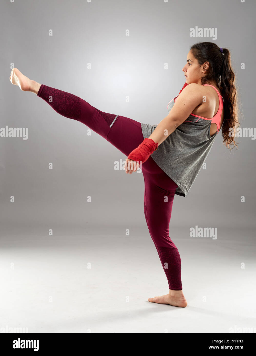 Young kickboxing female fighter in hand wraps, barefoot Stock Photo Alamy