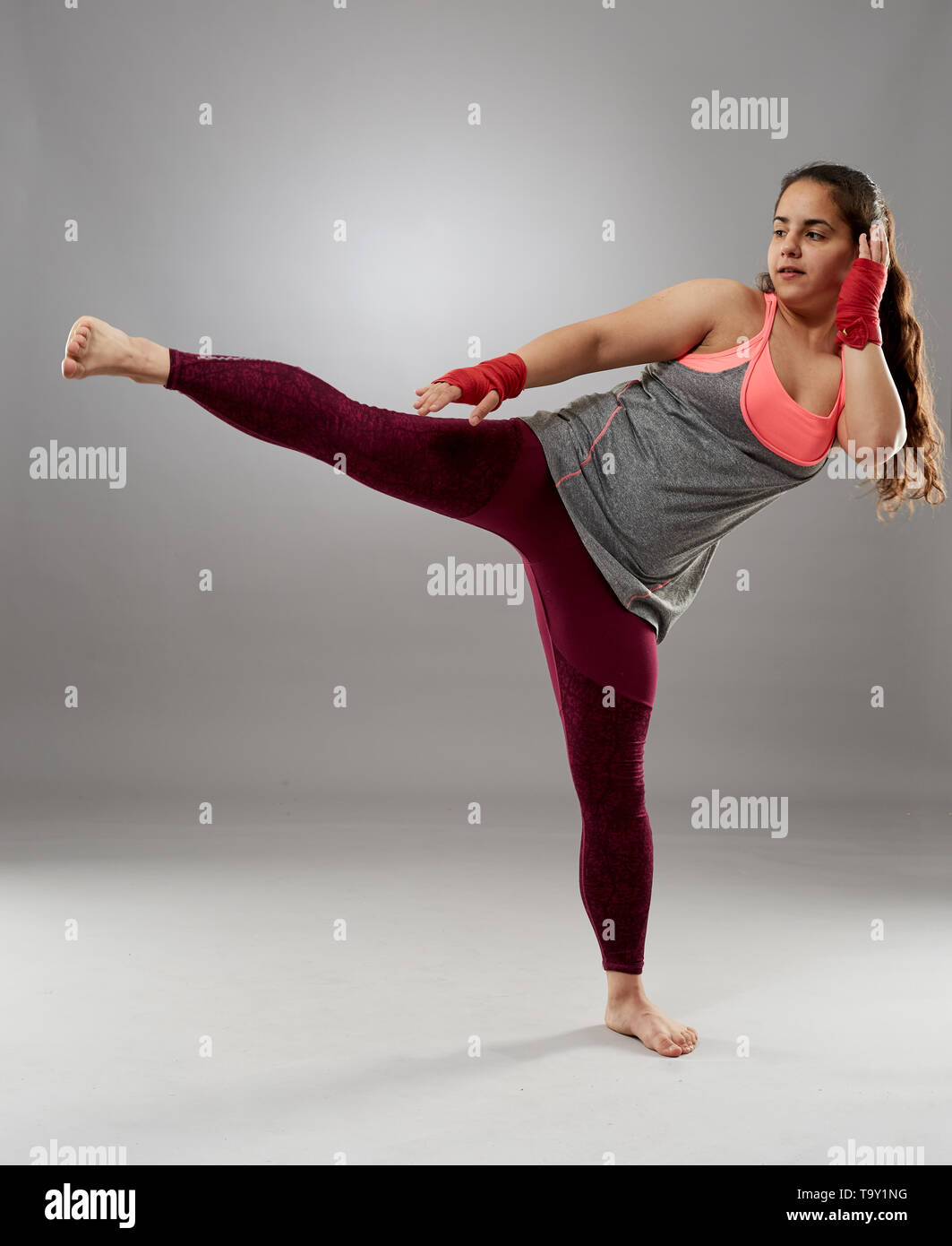 Young kickboxing female fighter in hand wraps, barefoot Stock Photo Alamy