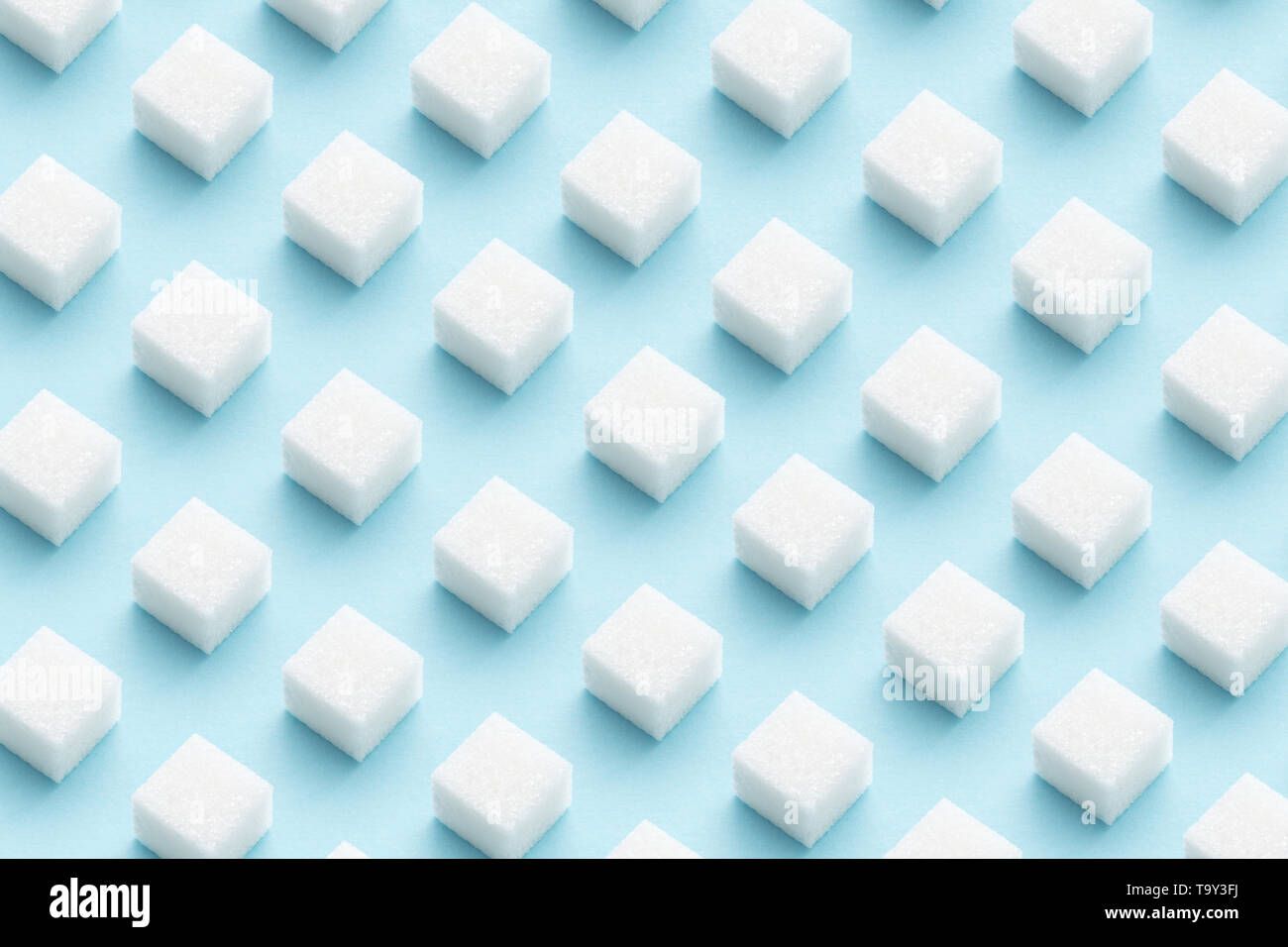Geometry Pattern made of white sugar cubes on light blue background. Abstract, minimal style. Trendy pastel color. Stock Photo