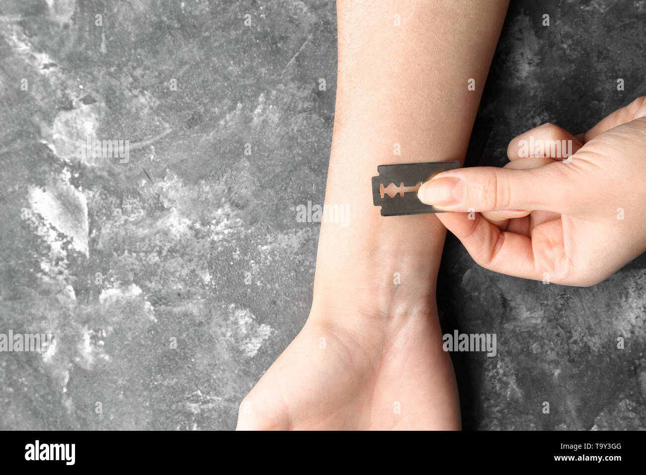 Woman cutting veins with razor blade on grey background. Suicide concept  Stock Photo - Alamy
