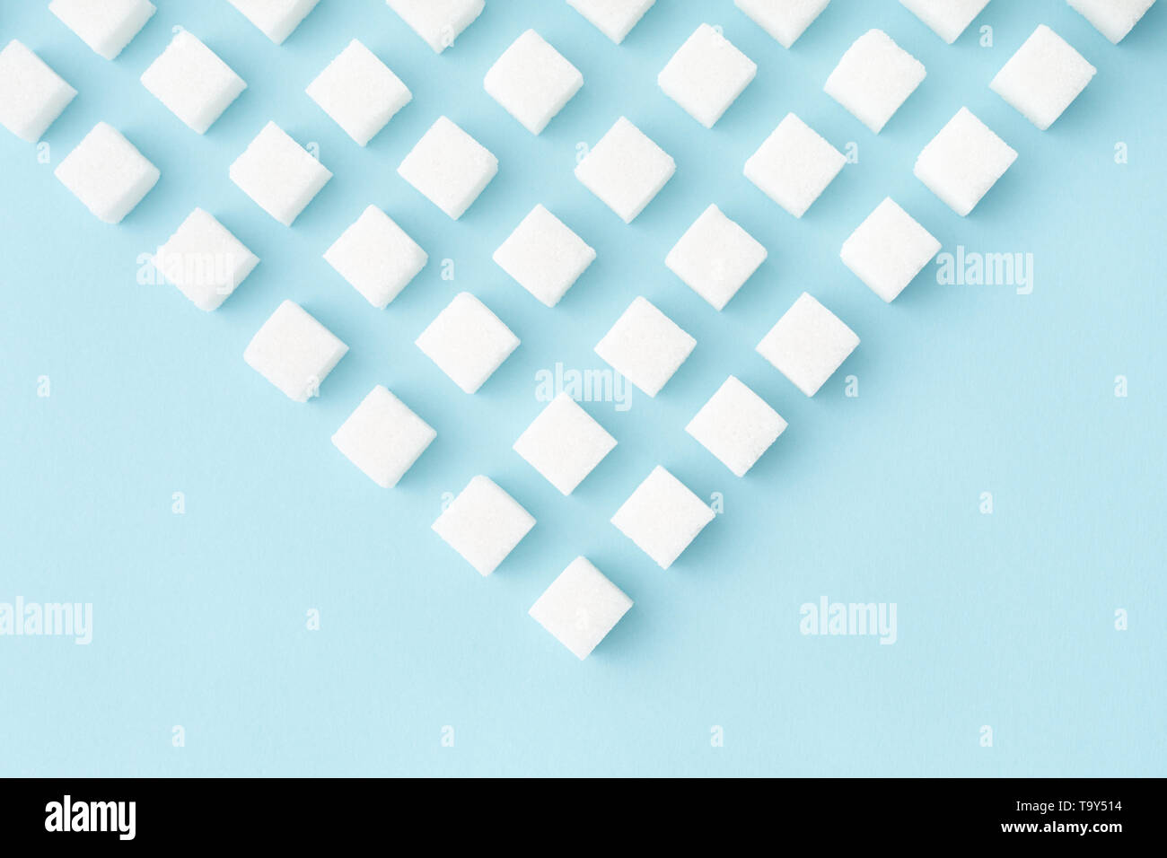 Sugar cubes geometry pattern on pastel blue background with copy space. Abstract, flat lay, minimal style. Stock Photo