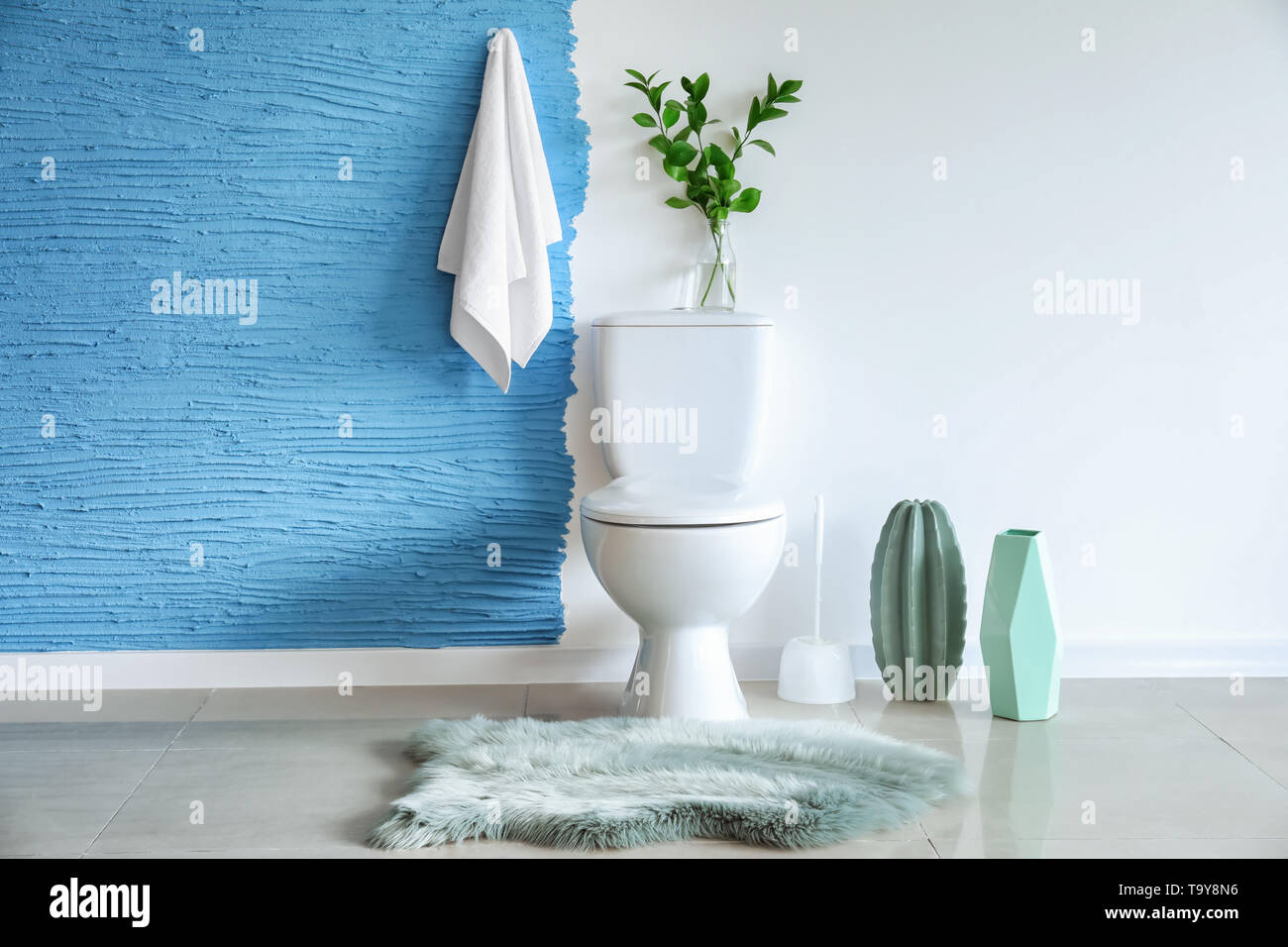 Modern interior of restroom with ceramic toilet bowl Stock Photo - Alamy