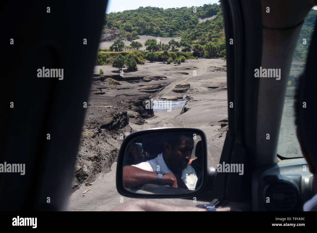 Driver checking river height over 4WD track across ashplain below Mt Yasur, Tanna, Vanuatu. No PR or MR Stock Photo