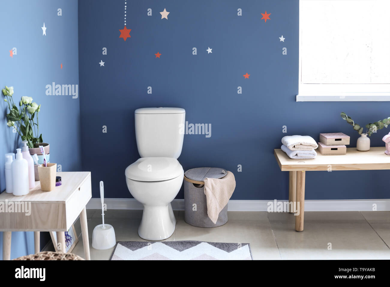 Modern interior of restroom with ceramic toilet bowl Stock Photo - Alamy