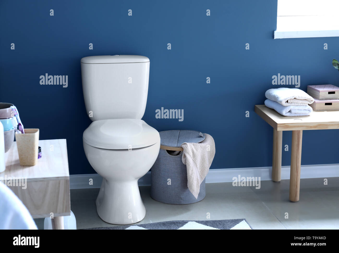 Modern interior of restroom with ceramic toilet bowl Stock Photo - Alamy