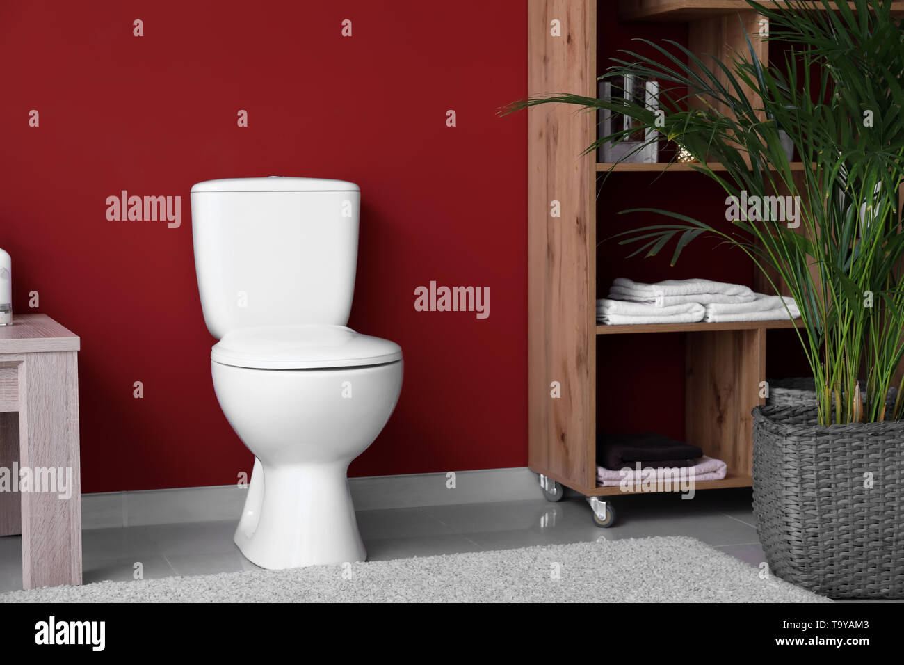 Modern interior of restroom with ceramic toilet bowl Stock Photo - Alamy