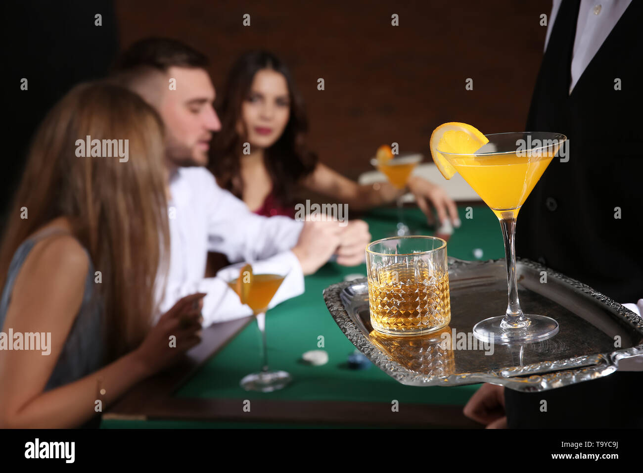 Waiter with alcohol drinks in casino Stock Photo Alamy