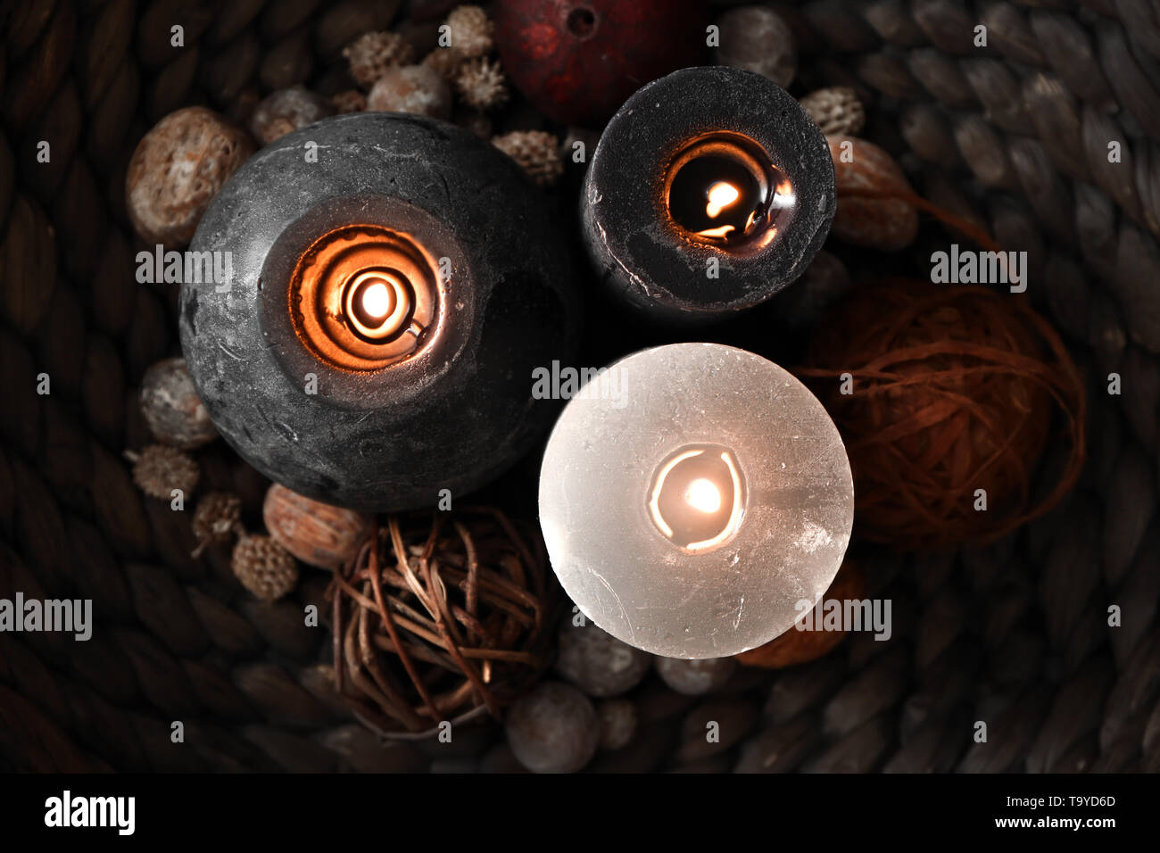 Beautiful burning candles on wicker tray, closeup Stock Photo Alamy