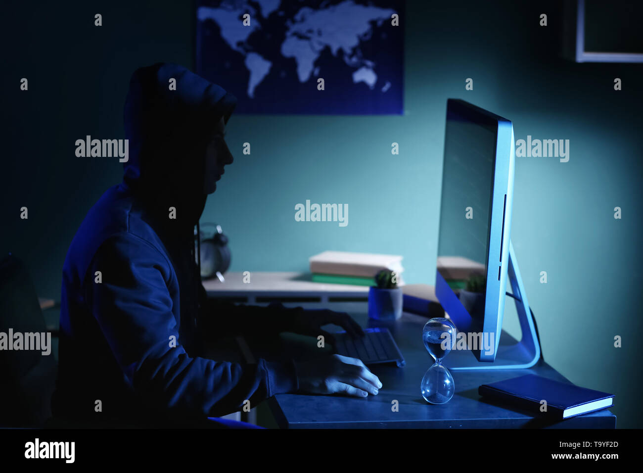 Professional hacker using computer in dark room Stock Photo - Alamy