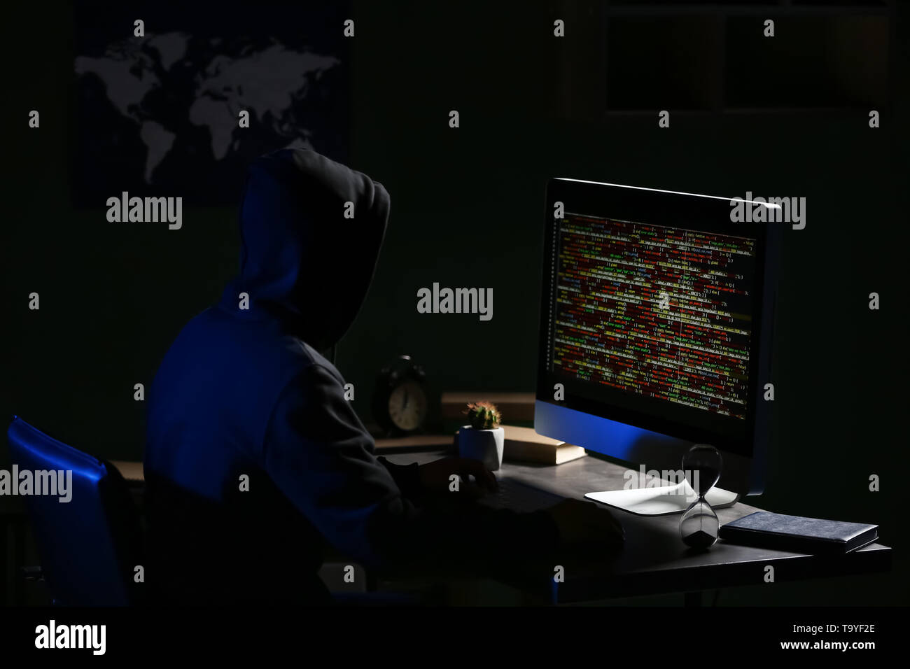 Professional hacker using computer in dark room Stock Photo - Alamy