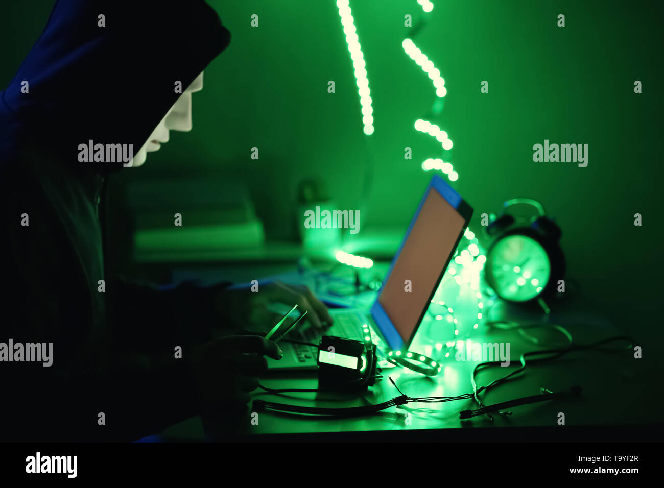Professional hacker working in dark room Stock Photo