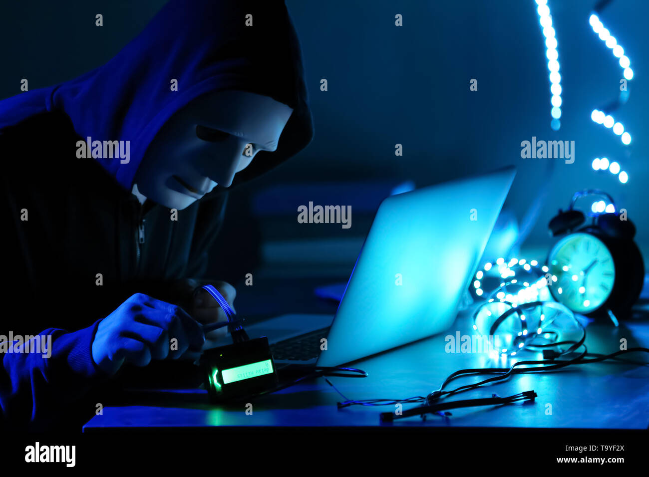 Professional hacker working in dark room Stock Photo