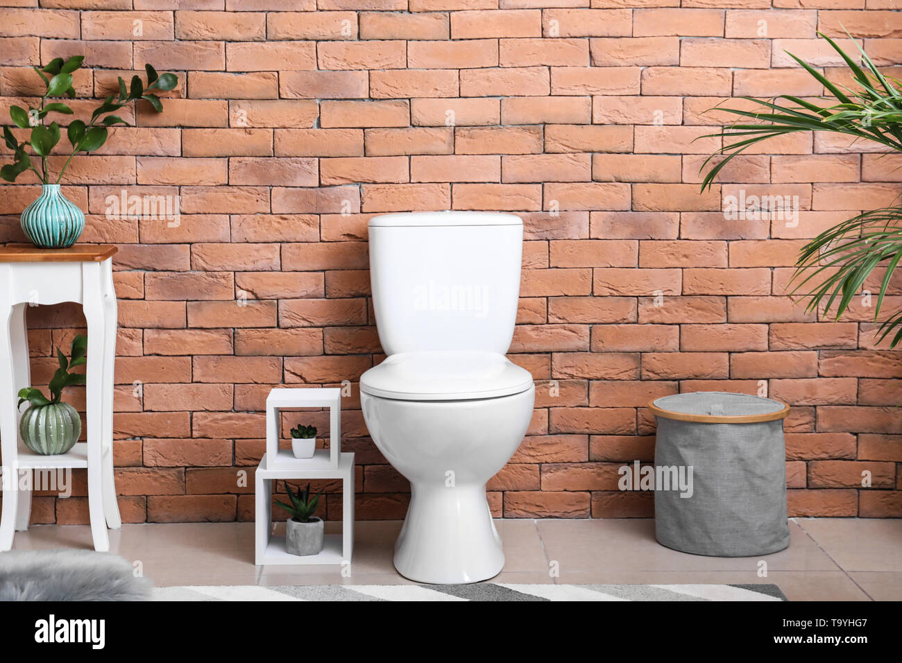 Interior of modern bathroom with toilet bowl Stock Photo - Alamy