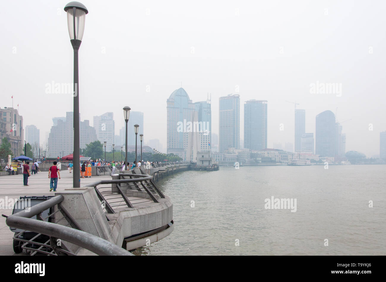 SHANGHAI, CHINA - JUN 2013: Tourists walk along the waterfront of Shanghai Stock Photo