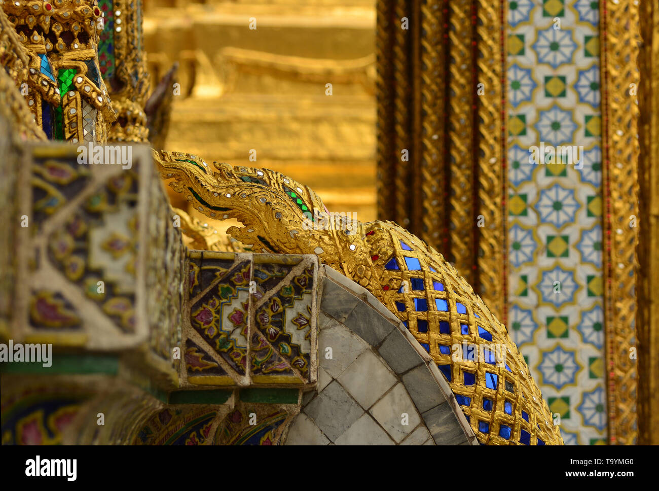 Detail of stairs railing with golden dragon relief in the grand palace in Bangkok Stock Photo