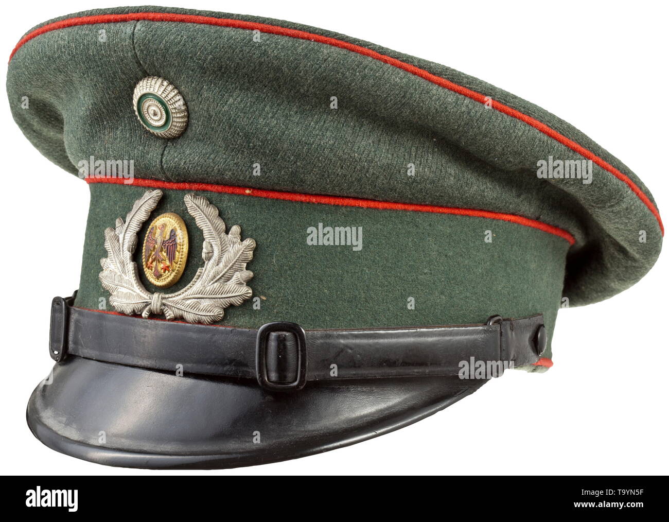 A Reichswehr visor cap for enlisted men/NCOs of the artillery Field-grey woollen cloth, green trim band, red piping, light brown inner liner, beneath the cap trapezoid the size designation '55', light brown leather sweatband, metal insignia, black patent leather straps. historic, historical, army, armies, armed forces, military, militaria, object, objects, stills, clipping, clippings, cut out, cut-out, cut-outs, 20th century, Editorial-Use-Only Stock Photo