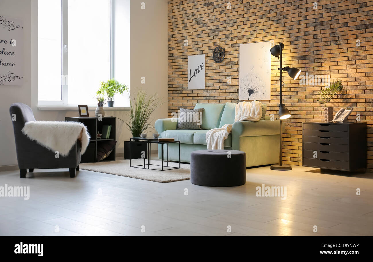 Stylish interior of living room with comfortable sofa Stock Photo - Alamy