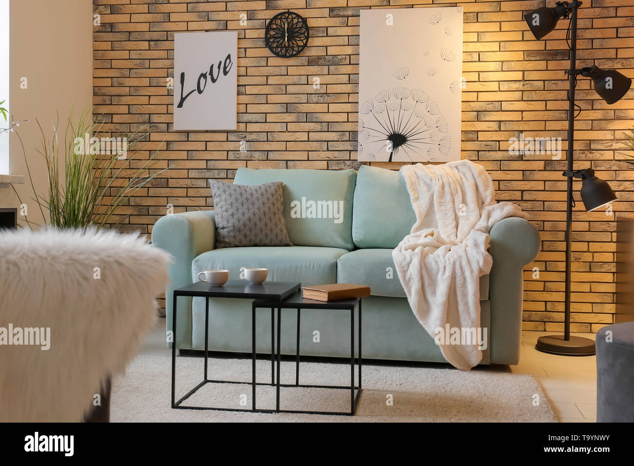 Stylish interior of living room with comfortable sofa Stock Photo - Alamy
