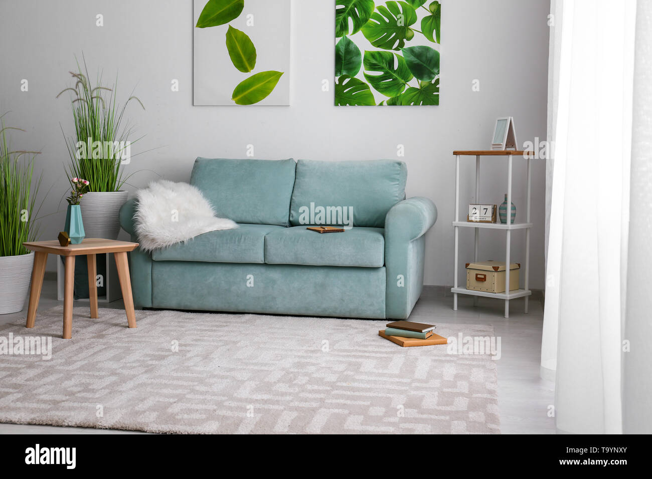 Stylish interior of living room with comfortable sofa Stock Photo - Alamy