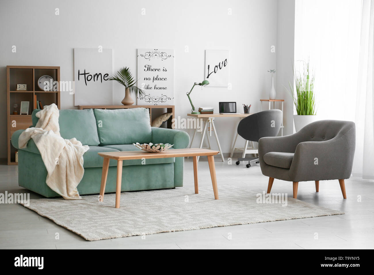 Stylish interior of living room with comfortable sofa Stock Photo - Alamy