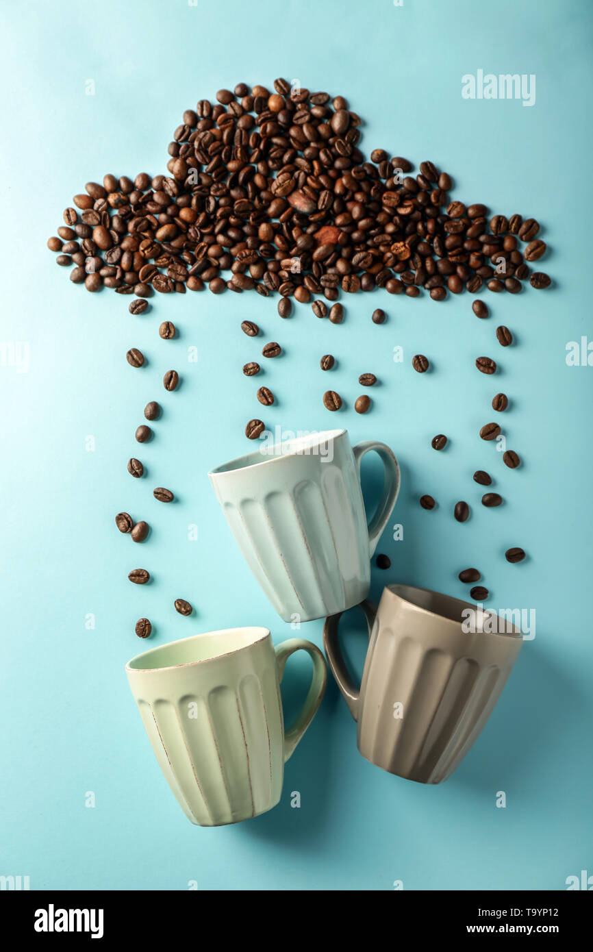 Creative composition with cups and coffee beans on color background Stock  Photo - Alamy