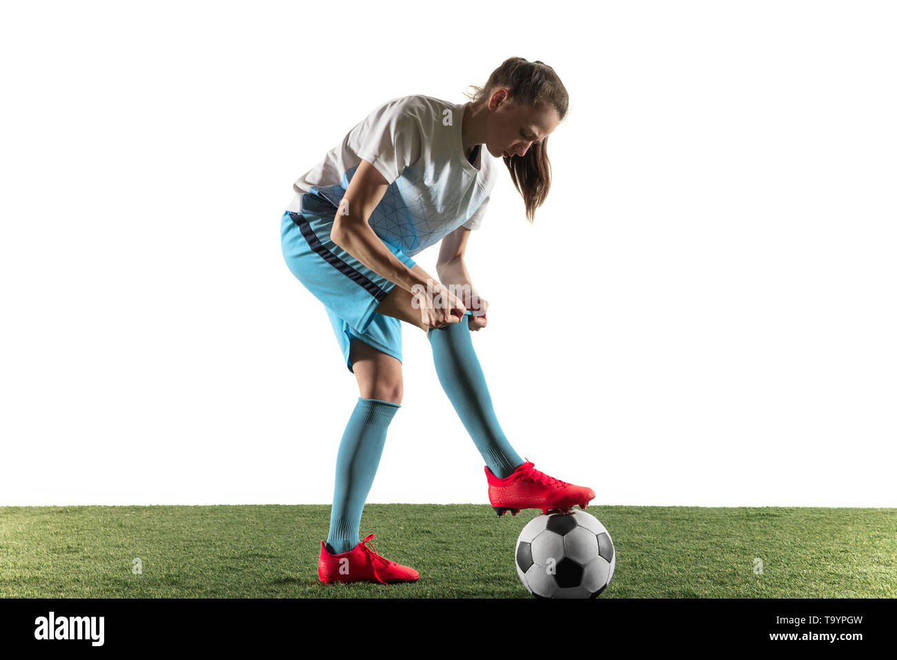 Young Female Football Or Soccer Player With Long Hair In Sportwear