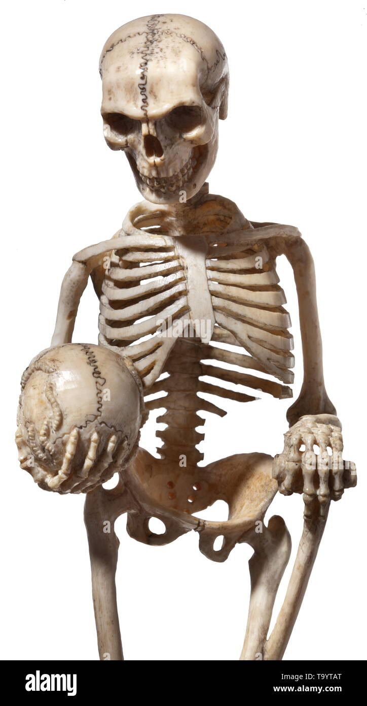 A German ivory figure of death, 19th century Standing, carved ivory skeleton  of one piece. Holding in his right hand a worm-eaten skull, resting his  left on a shovel. Rectangular plinth with