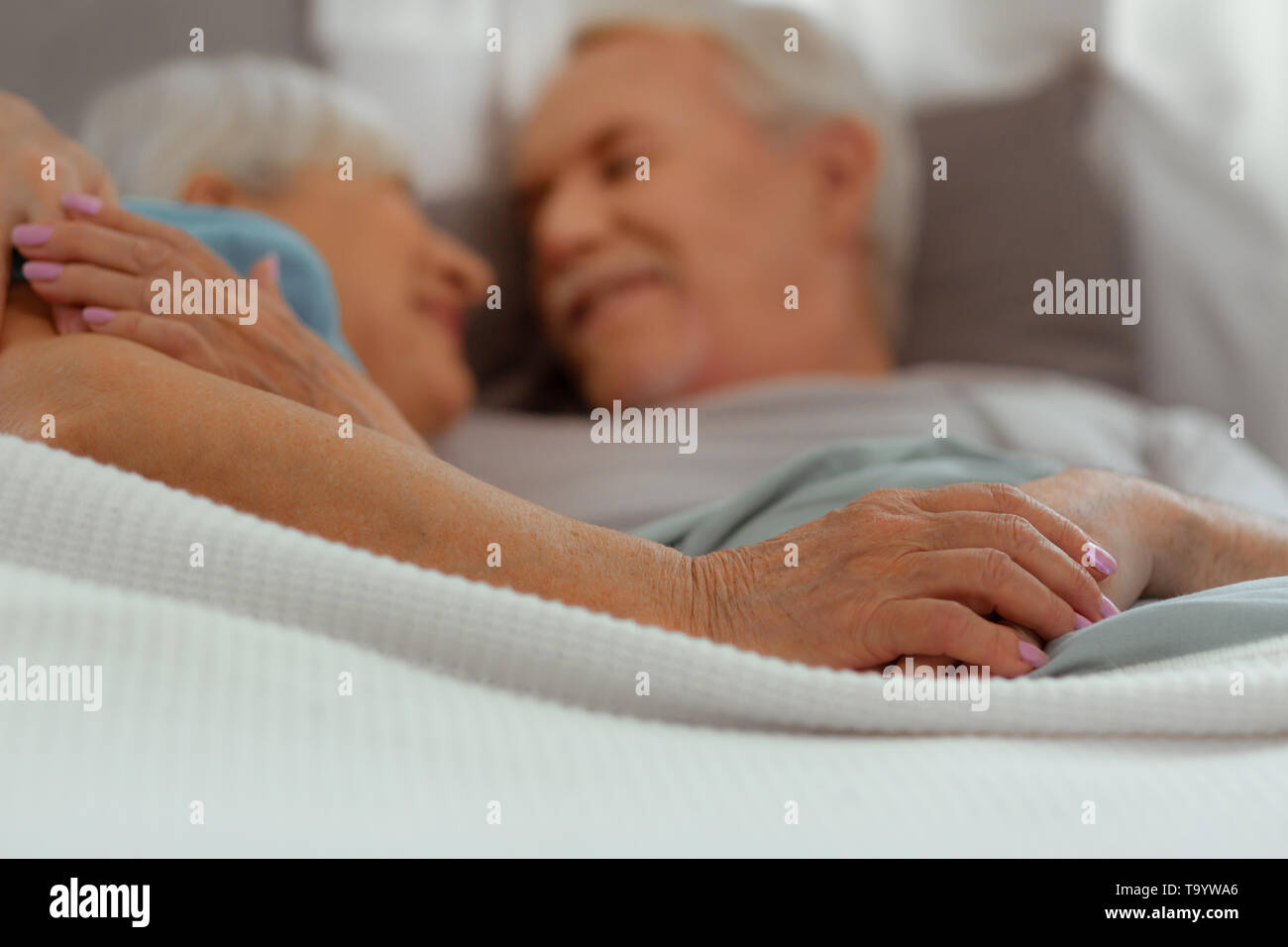 Old couple embracing in bed hi-res stock photography and images - Alamy