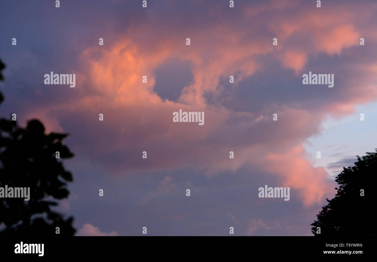 dark clouds in sunset light Stock Photo