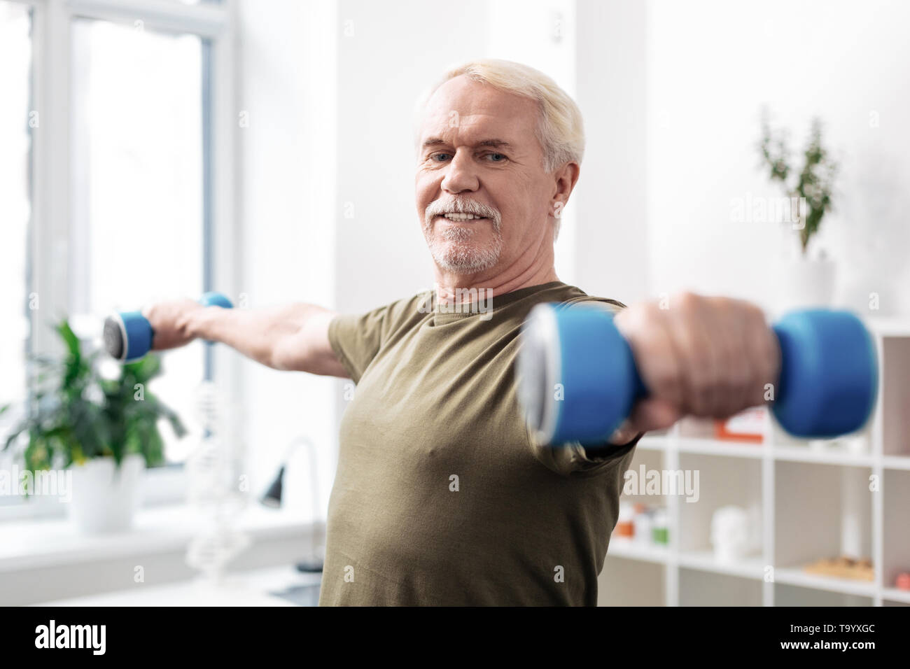 Nice active aged man practicing physical activities Stock Photo