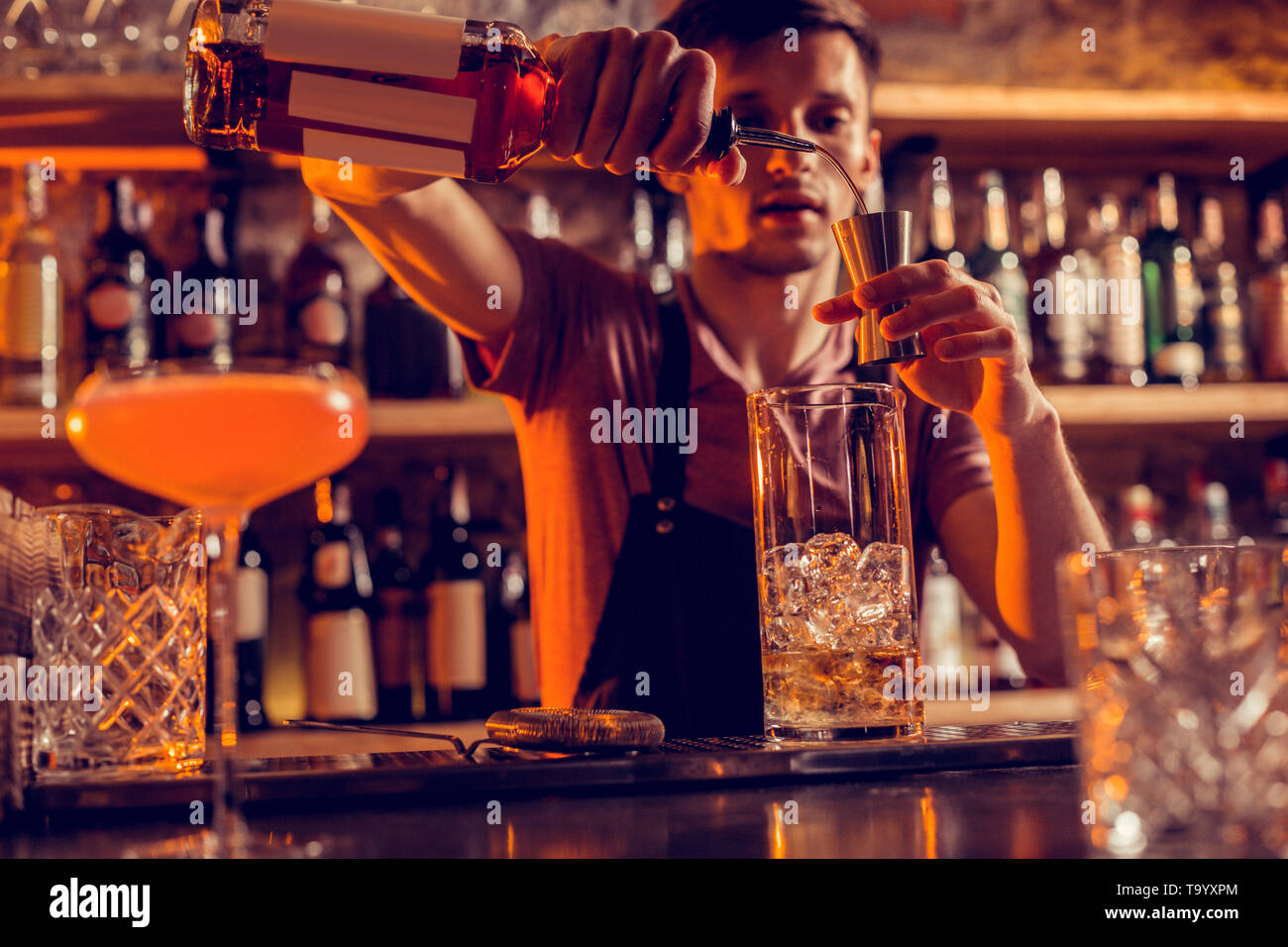 Busy barman making cocktails for clients at night Stock Photo Alamy
