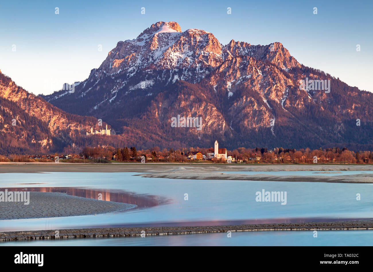 View over dry lake Forggensee to Neuschwanstein castle, Bavaria, Germany Stock Photo