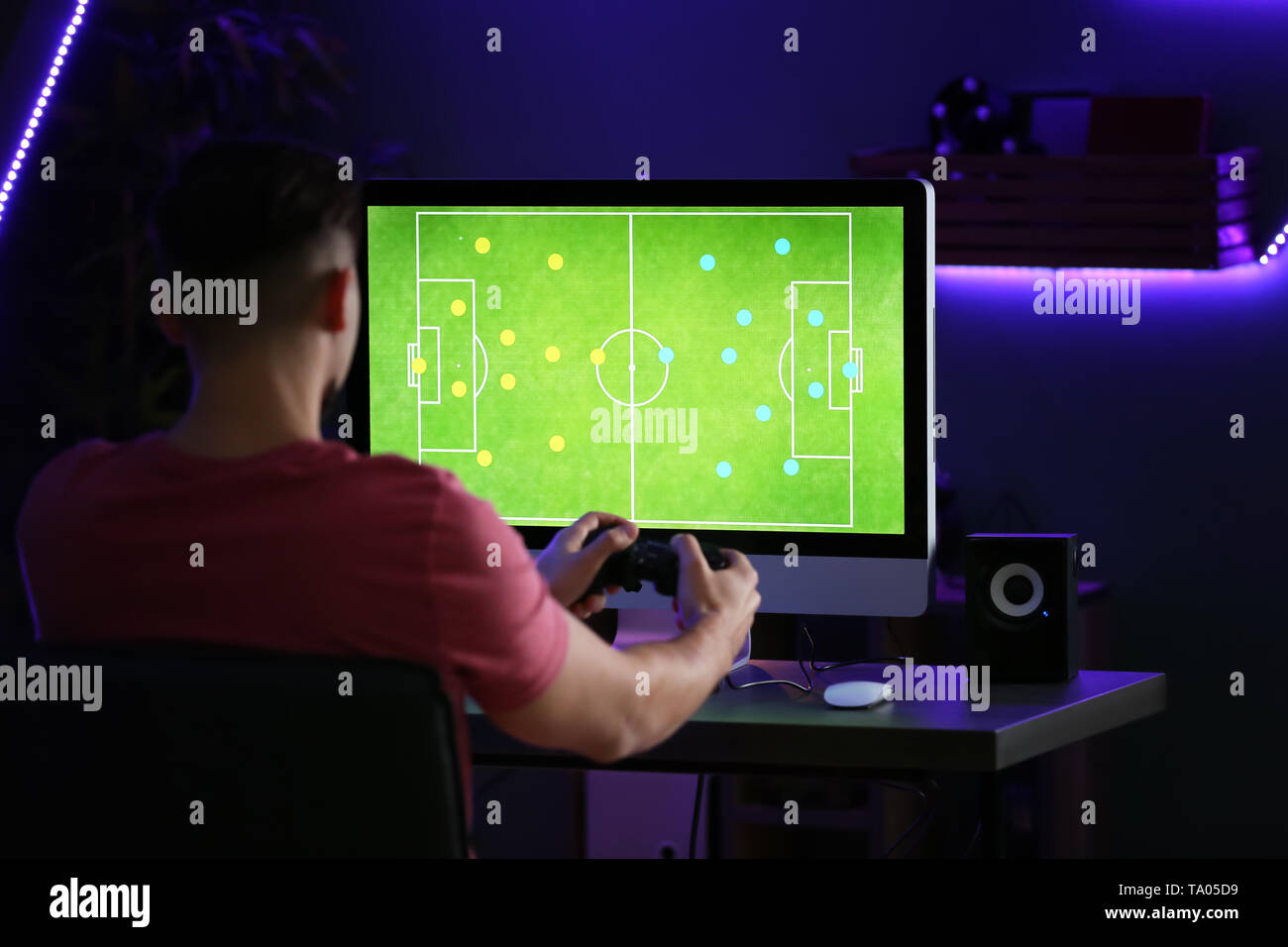 Young man playing computer game in club Stock Photo - Alamy