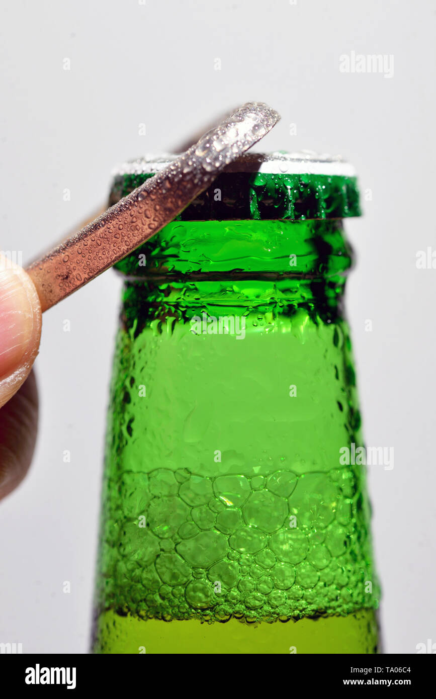 Detail of Man Hand Opening Beer Bottle Stock Photo